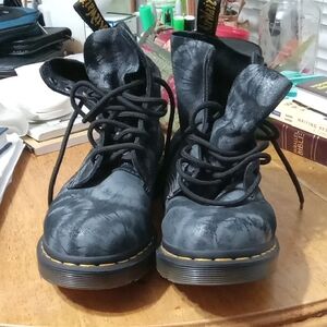 Dr. Martens Black Leather Lace-Up Boots with Yellow Accents.